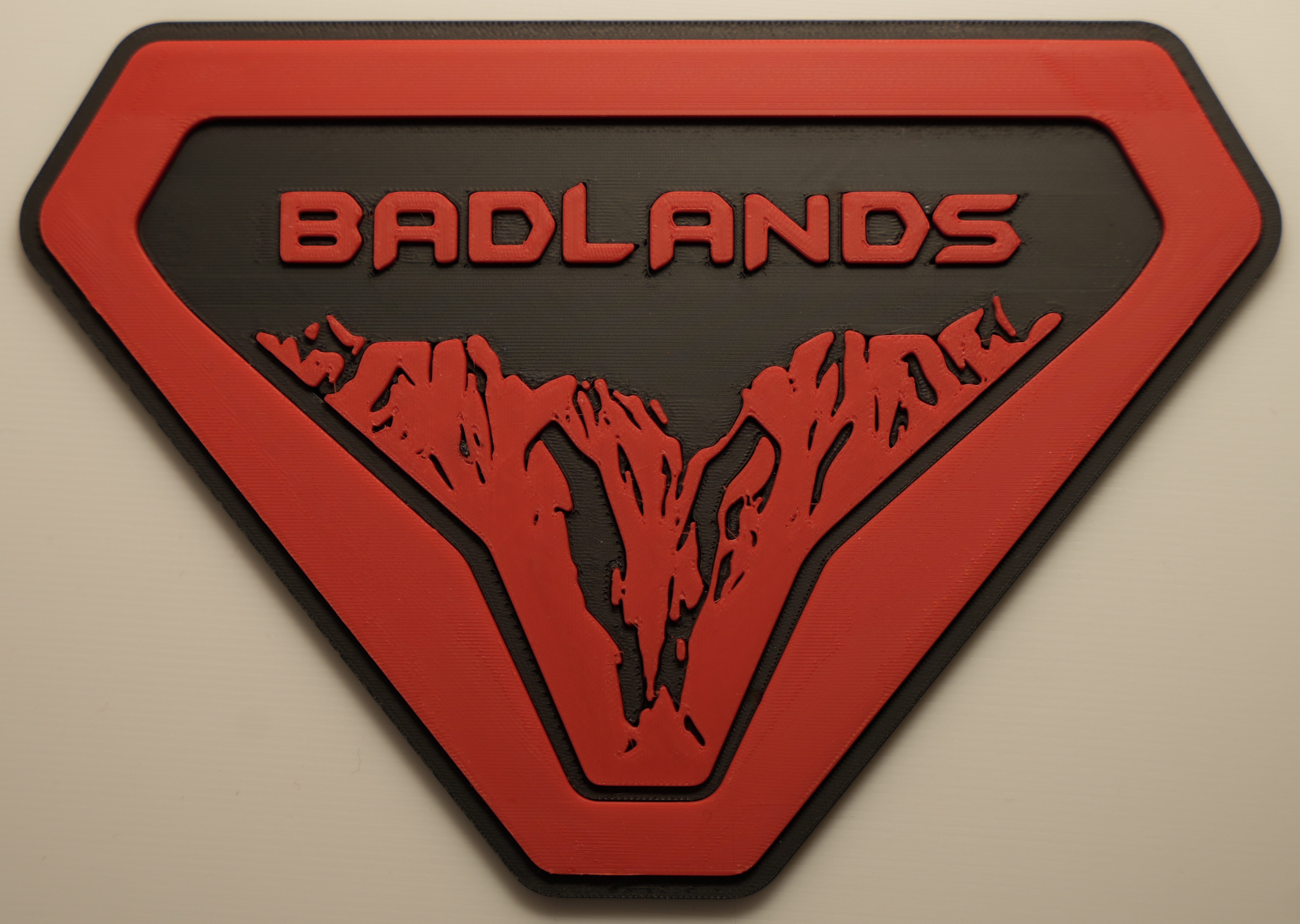Red and black custom 3D printed Badlands badge