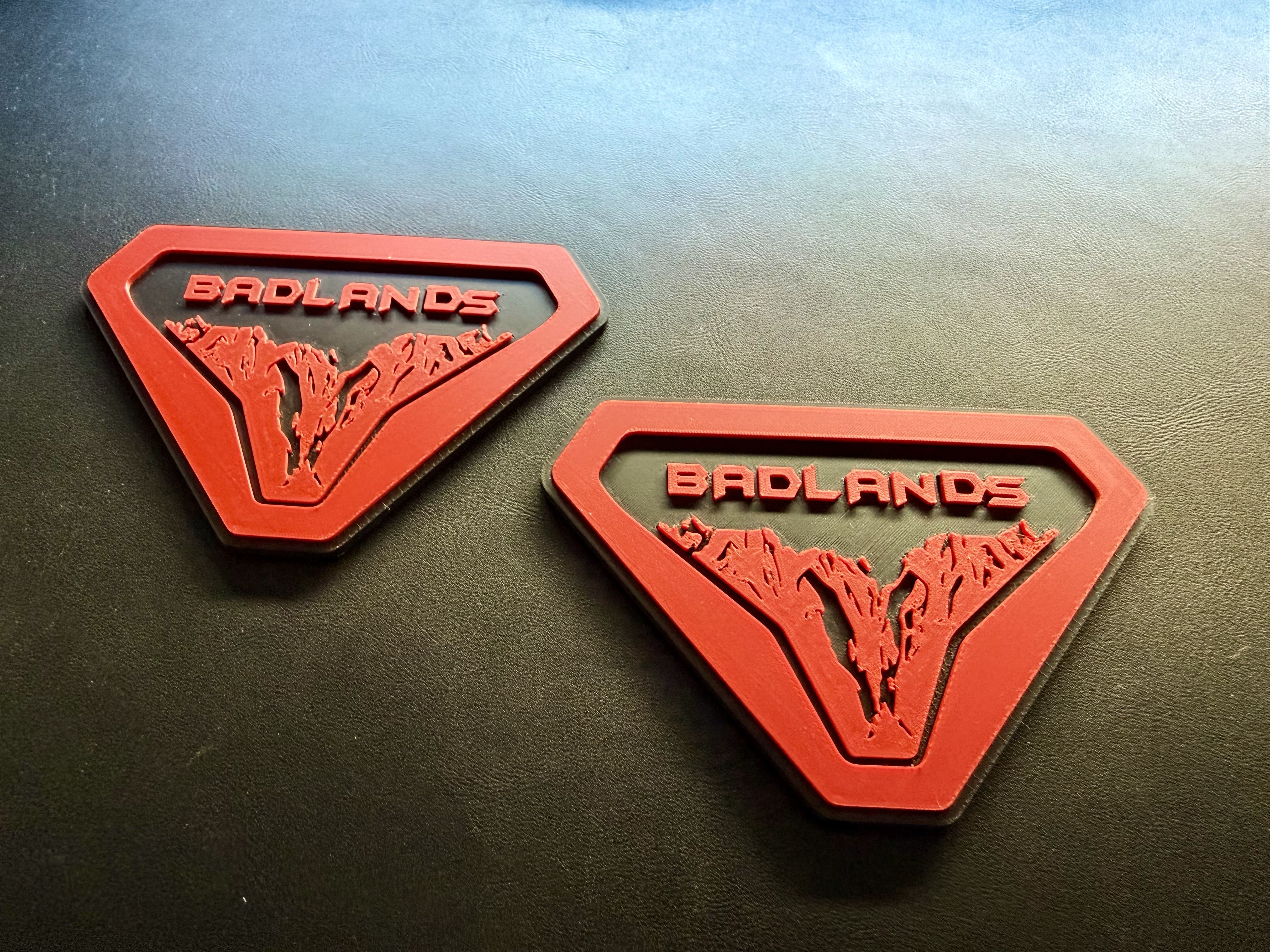 Pair of red and black custom 3D printed fender badges